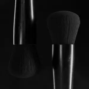 The Heads of cosmetic brushes displayed in a dark environment